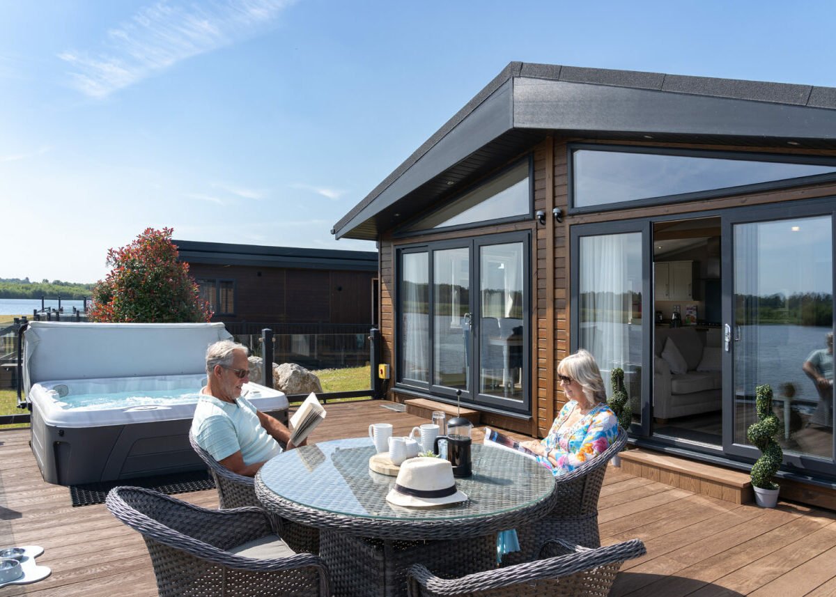Couple enjoying the outside decking on their luxury holiday home.
